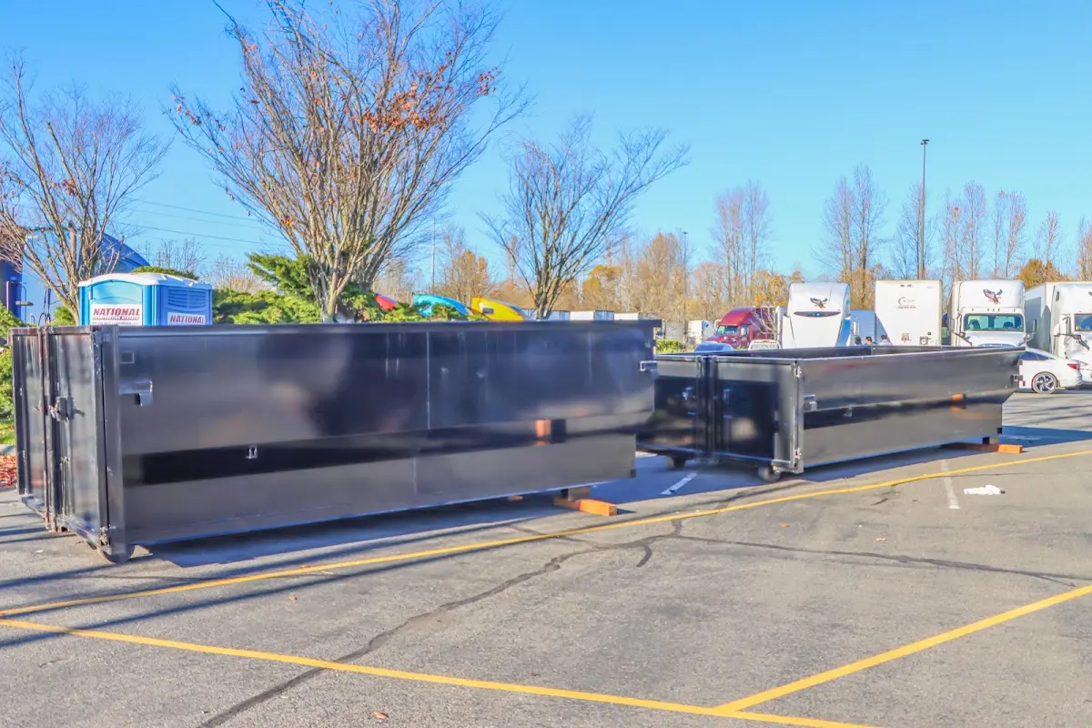 Professional dumpster rental service with roll-off container on residential driveway in Pembroke Pines